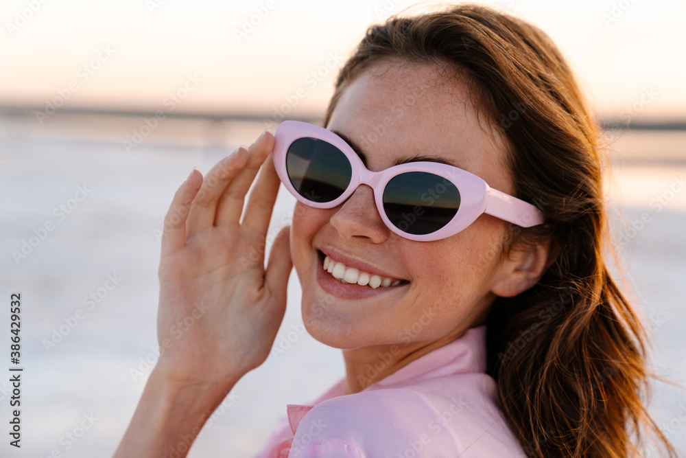 Smiling young girl in sunglasses posing outdoors Smiling young girl in sunglasses posing outdoors