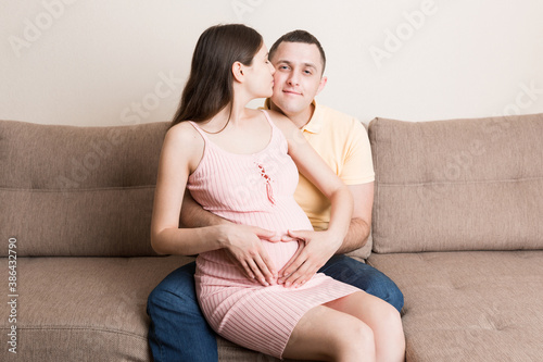 Pregnancy, expectation of a couple of child. Future parents with hands in the form of heart. The man put his hand on the woman's tummy