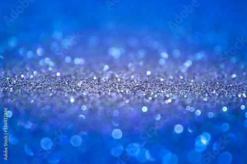 Winter, Christmas xmas background. Blue abstract background with selective focus in the middle. Blue glitter bokeh vintage lights, Happy holiday new year, defocused. Space for text. Template