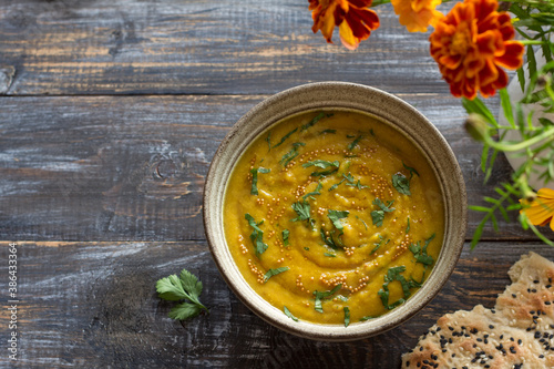 Indian lentil masurdal soup with turmeric, ginger and herbs, top view, free space photo