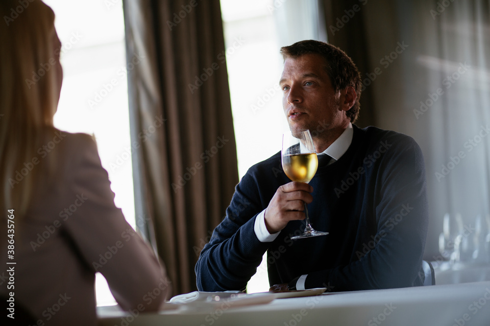 Handsome businessman drinking wine. Businessman enjoying in the restaurant. Handsome businessman drinking wine. Businessman enjoying in the restaurant.