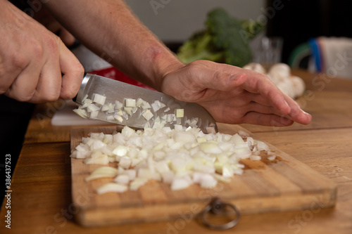 Hands chopping and preparing vegetables. 