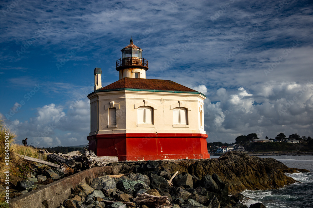red and while lighthouse in a river