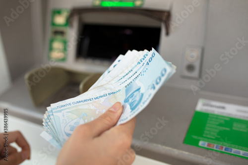 Fototapeta Naklejka Na Ścianę i Meble -  Money banknotes ATM woman hand. Turkish lira economy concept.
