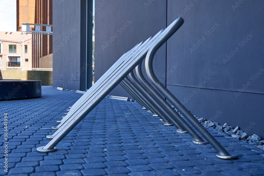Fototapeta premium Modern bicycle stand near the building
