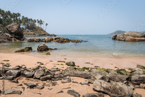 View of the bay with a village under palm trees near the Indian ocean © Sergey