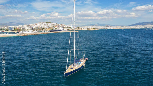 Aerial drone photo of beautiful luxury sailboat with wooden deck anchored near famous marina of Zea, Piraeus, Attica, Greece © aerial-drone