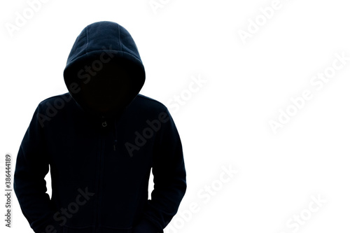 A man with a hood does not see his face. Danger in the dark On a white background With a blank space on the right for text or design
