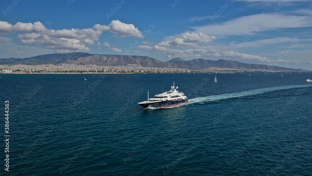 Aerial drone photo of large luxury yacht with wooden deck cruising in high speed in deep blue Aegean sea