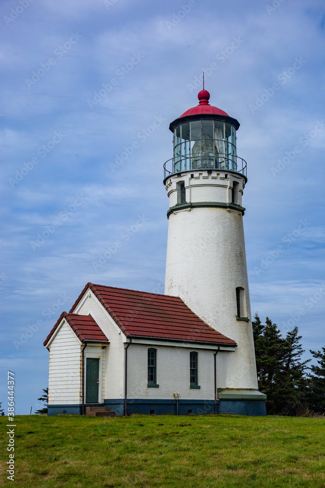 red and white lighthouse on a grassy hill red and white lighthouse on a grassy hill
