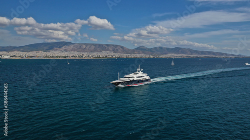 Aerial drone photo of large luxury yacht with wooden deck cruising in high speed in deep blue Aegean sea © aerial-drone