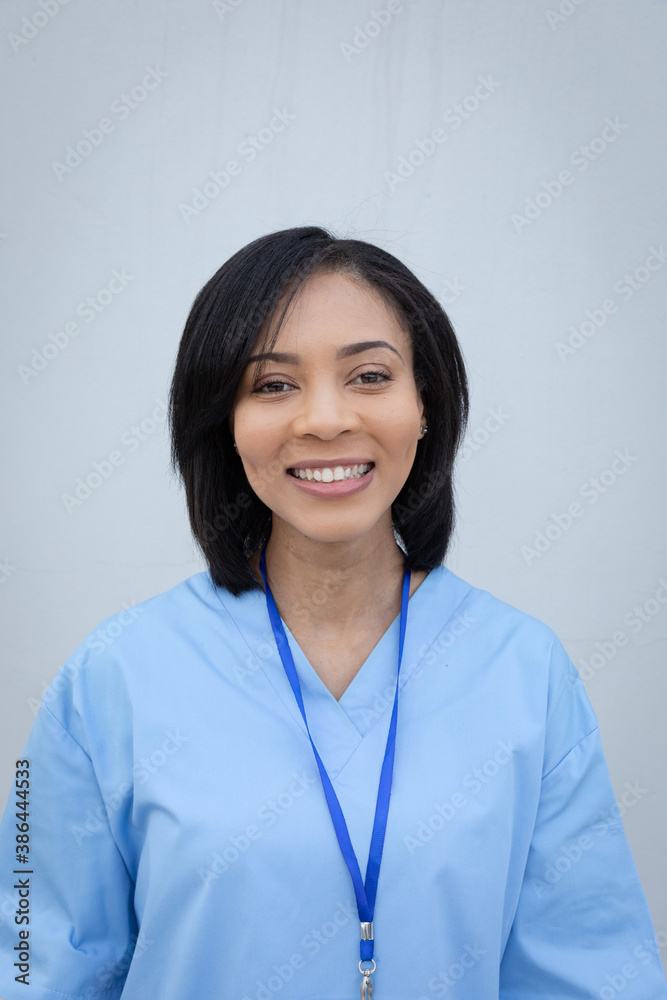 Portrait of female health professional against grey background Portrait of female health professional against grey background