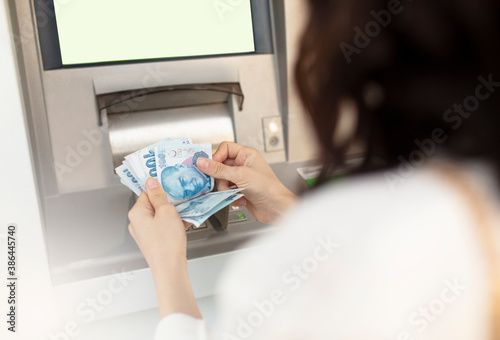 Money banknotes ATM woman hand. Turkish lira economy concept.
