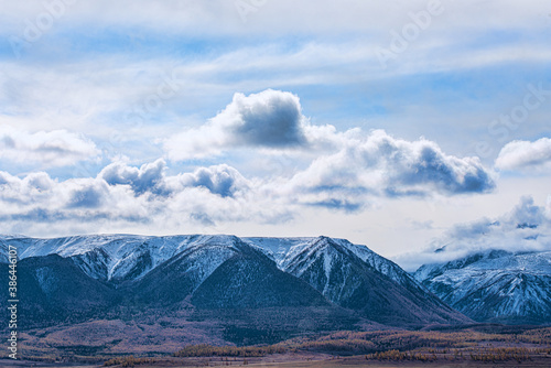panoramic view of picturesque snowy mountains tops on blue sky background