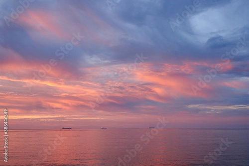 Fototapeta Naklejka Na Ścianę i Meble -  Sunset on the sea, ships standing on the horizon.