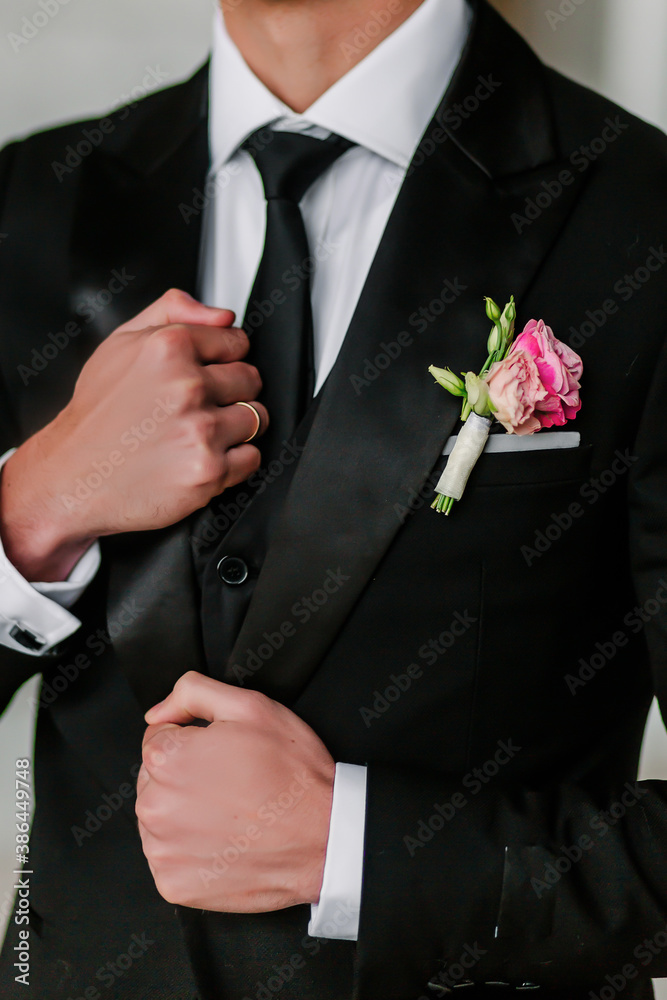Groom in a classic suit with a boutonniere for a wedding Groom in a classic suit with a boutonniere for a wedding