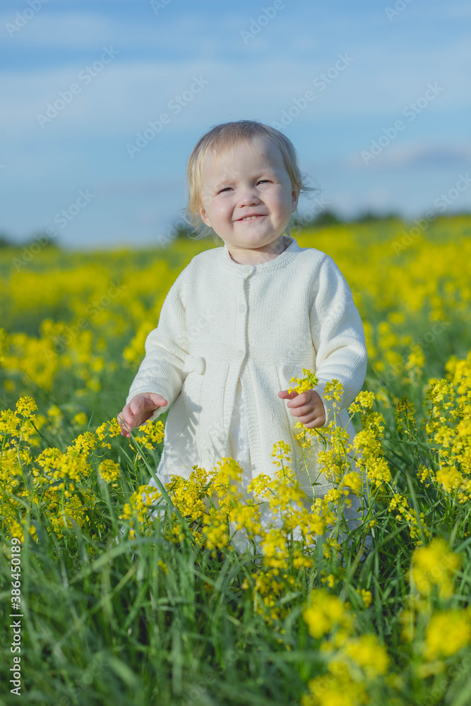 girl in a field of yellow flowers