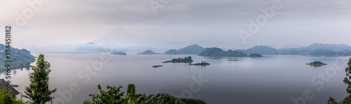 Panorama of Lake Mutanda at morning with view on the volcanoes mount Muhavuru and mount Gahinga in East Africa  along the border of Rwanda and Uganda. 