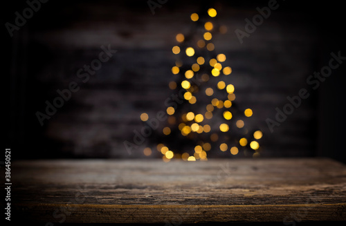 Obraz na płótnie blurred background of xmas tree lights and wall wooden board and free place w salonie