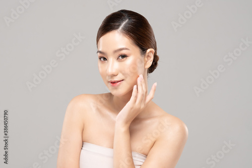 Beautiful Asian woman touching soft cheek smile with clean and fresh skin Happiness and cheerful with positive emotional,isolated on white background,Beauty and Cosmetics Concept