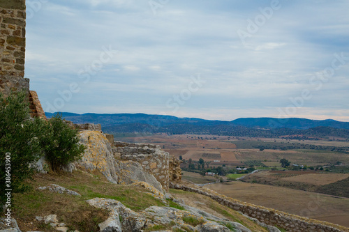 View from castle of farm fields and mountains in the background photo