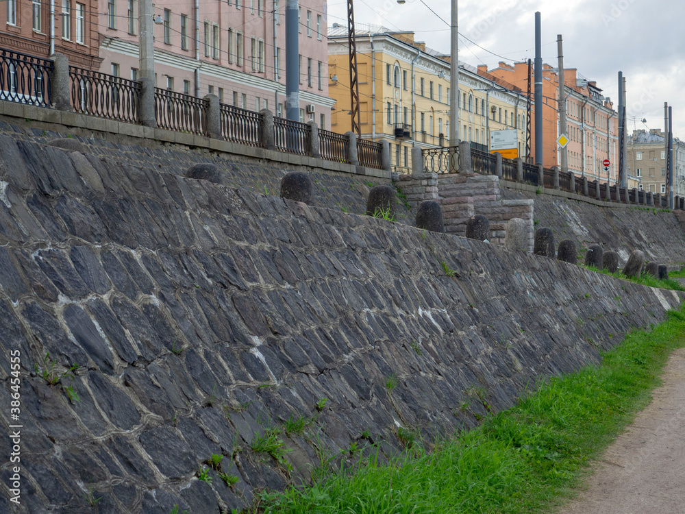 old paved stone embankment and fence posts in the historical part of the city