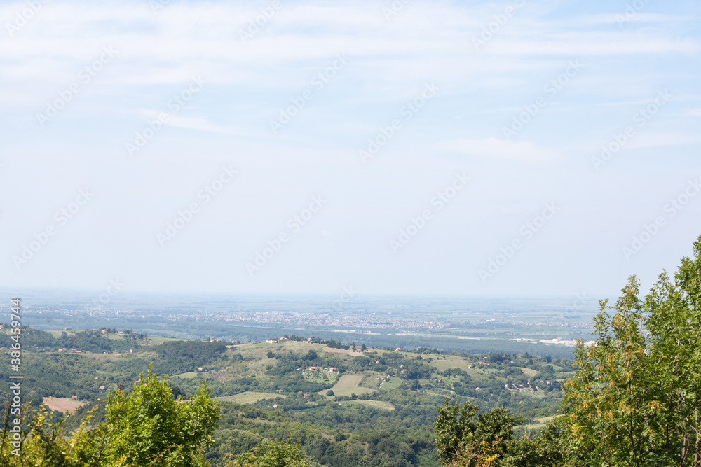 Aerial panoramal of Novi Sad, seen from a hill of Fruska Gora National park during a summer afternoon. Novi Sad is the capital city of Vojvodina and a major place in Serbia