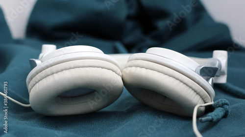 White elegance headfones on blue textile photo