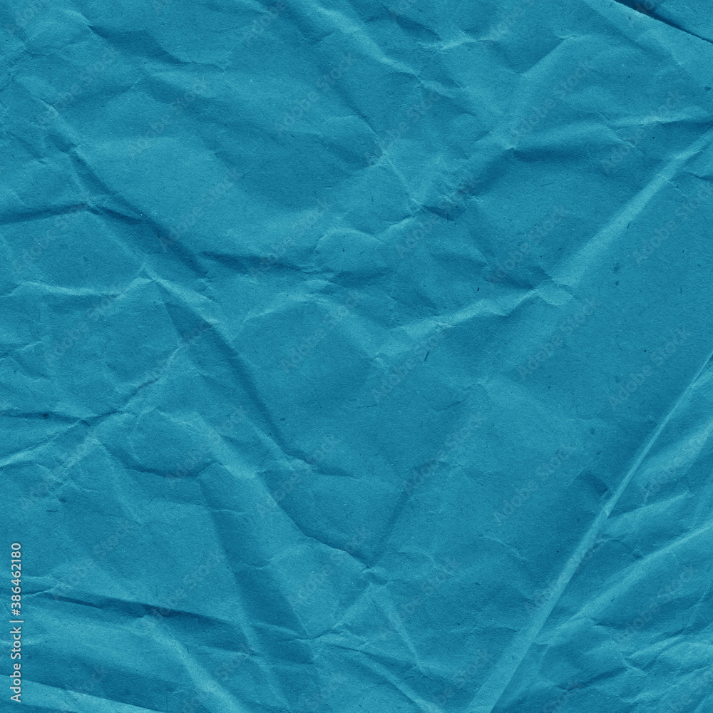 Blue vintage and old looking crumpled paper background. Retro cardboard texture. Grunge paper for drawing. Ancient book page. Present wrapping.