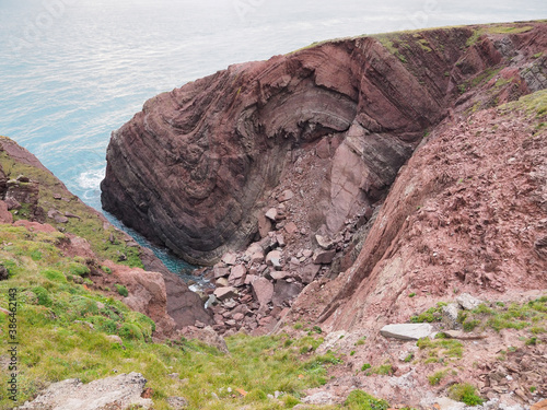 Cobblers Hole, St. Anns Head, and the splendid anticline and syncline fold couplet in the Devonian-age Old Red Sandstone rock, south Pembrokeshire coast, Wales, UK photo