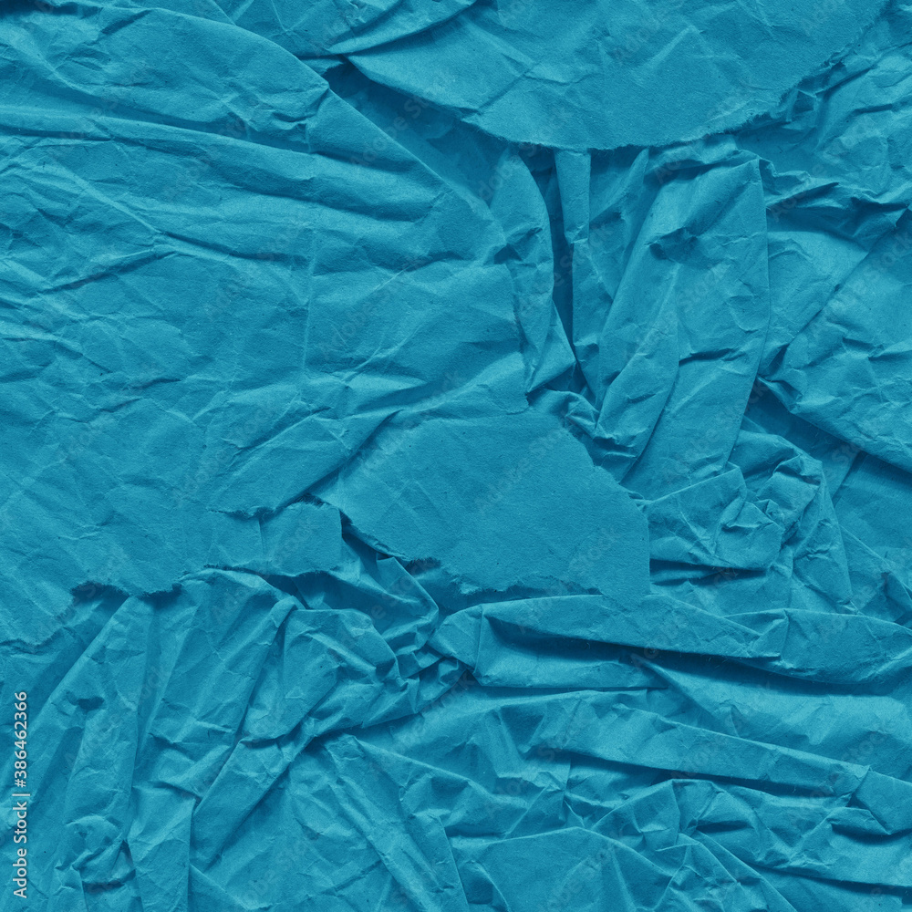 Blue vintage and old looking crumpled paper background. Retro cardboard texture. Grunge paper for drawing. Ancient book page. Present wrapping.