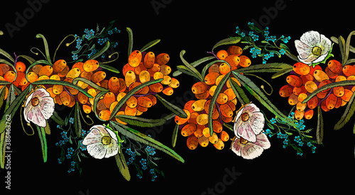 Sea buckthorn berries branch and white flowers. Embroidery, horizontal seamless pattern. Fashion template for design of clothes, tapestry. Autumn garden art