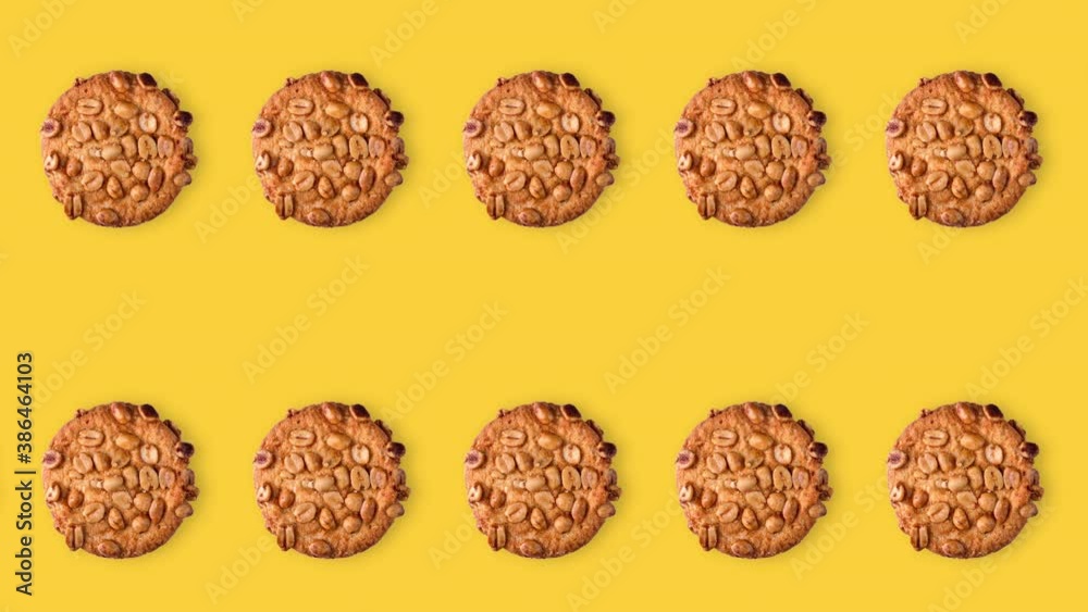 seamless looping animation of peanut cookies. two rows of homemade pastries animated on a yellow background