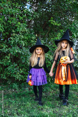 Halloween little girls in witch costume out for trick-or-treating