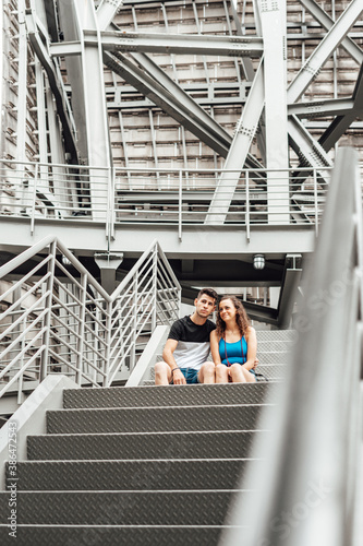 Foto Young couple on an industrial staircase