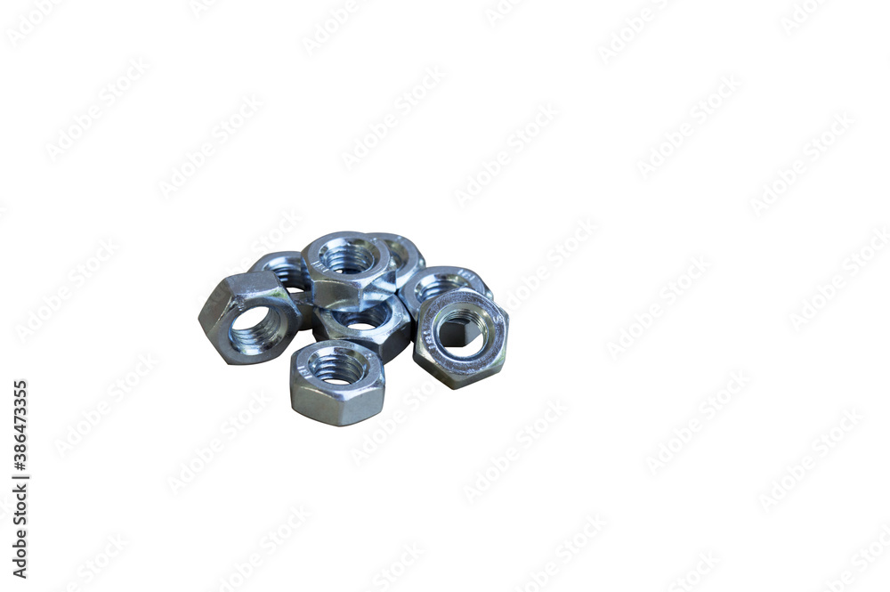 Metal nuts lie in a heap on the surface. Galvanized nuts. Chrome plated nuts. Isolated. Metal nuts lie in a heap on the surface. Galvanized nuts. Chrome plated nuts. Isolated.