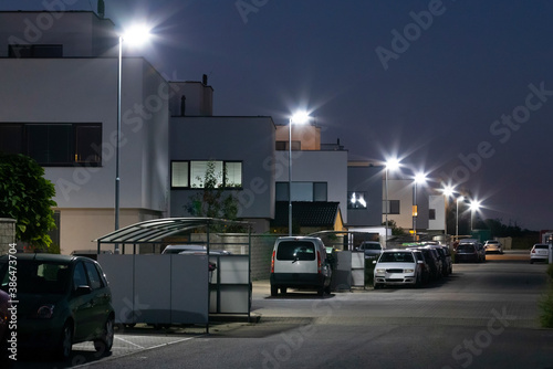 Fototapeta Naklejka Na Ścianę i Meble -  modern street with apartment building and led street lights