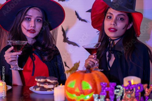 young Asian woman wearing costume in Halloween festival party photo