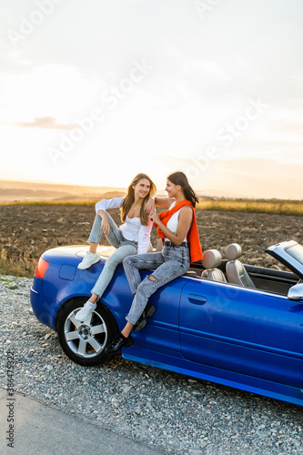 Two happy women friends taking selfie when road trip in convertible car. © F8  \ Suport Ukraine