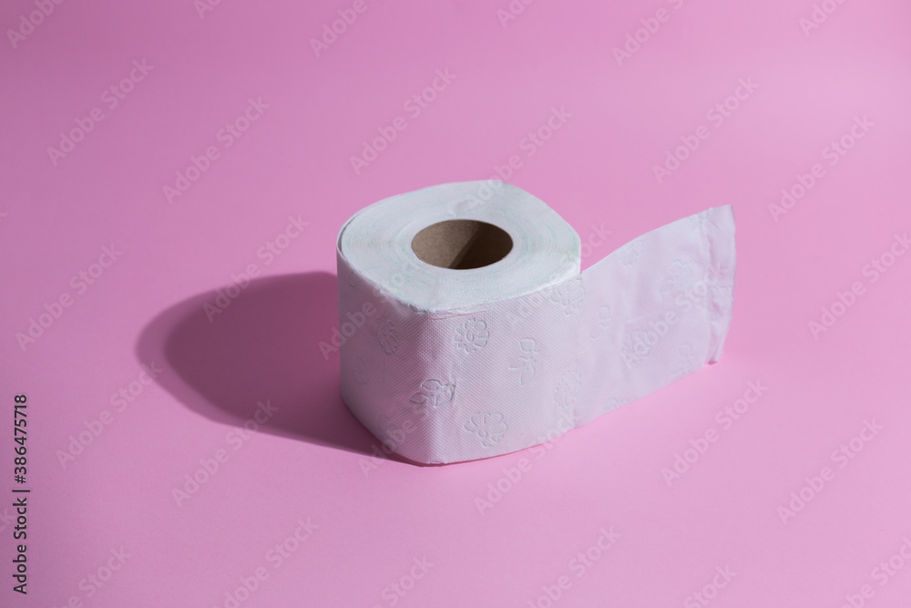 Toilete paper on a pink background. Minimal concept. Toilete paper on a pink background. Minimal concept.