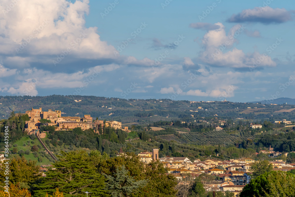 Panoramic view of Certaldo lit by the late afternoon sun, against a beautiful sky, Tuscany, Italy