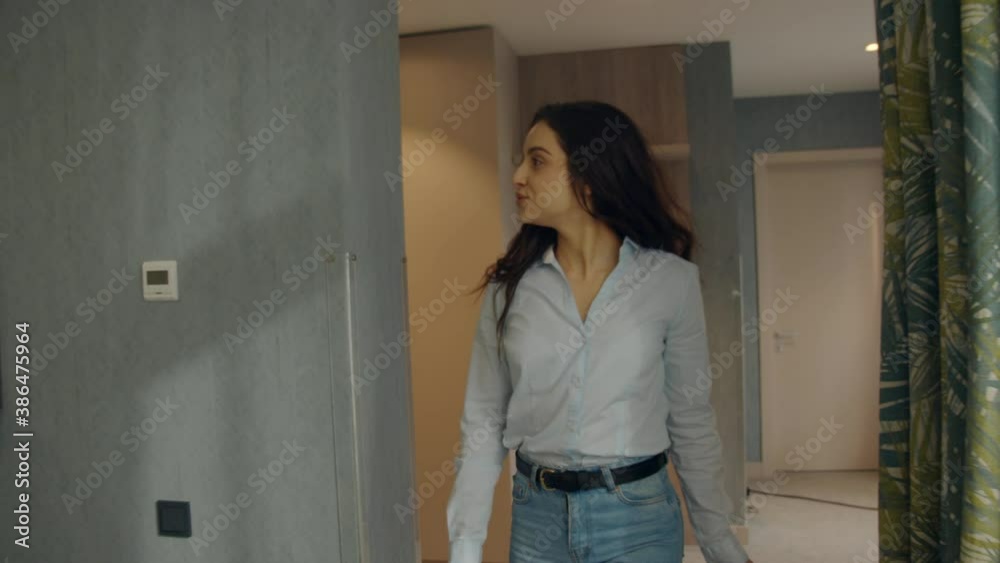 Sweet woman looking around in luxury apartment. Cute girl relaxing on hotel bed Sweet woman looking around in luxury apartment. Cute girl relaxing on hotel bed