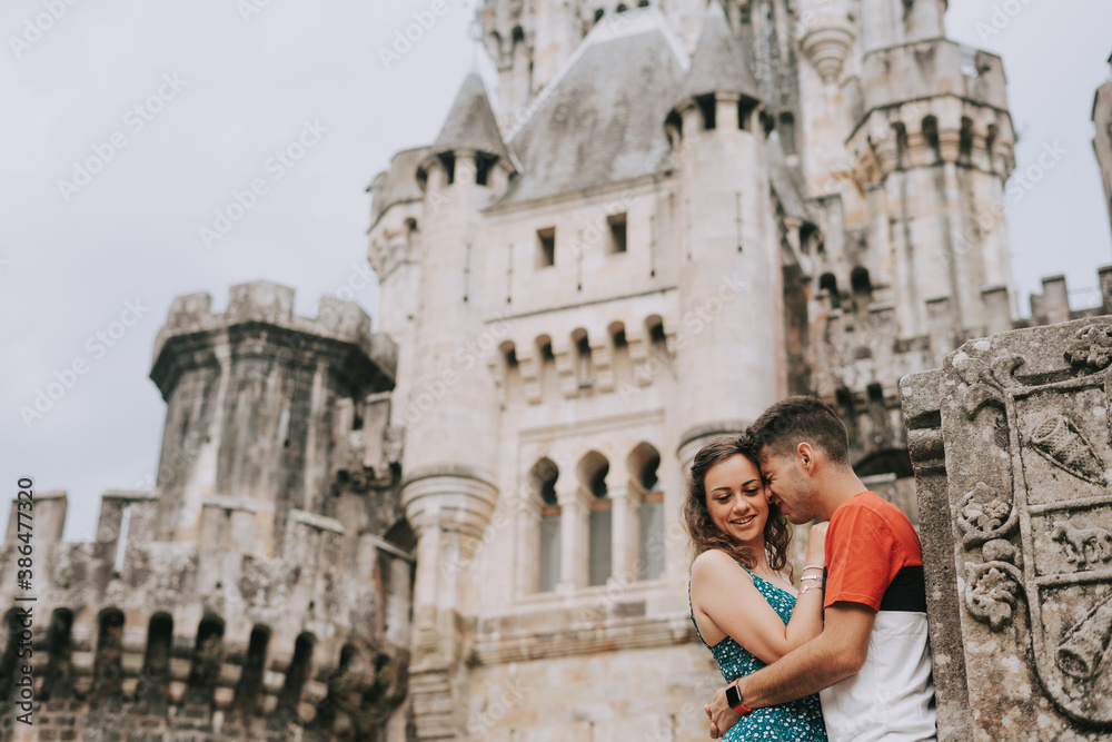 Young couple in front of a medieval castle