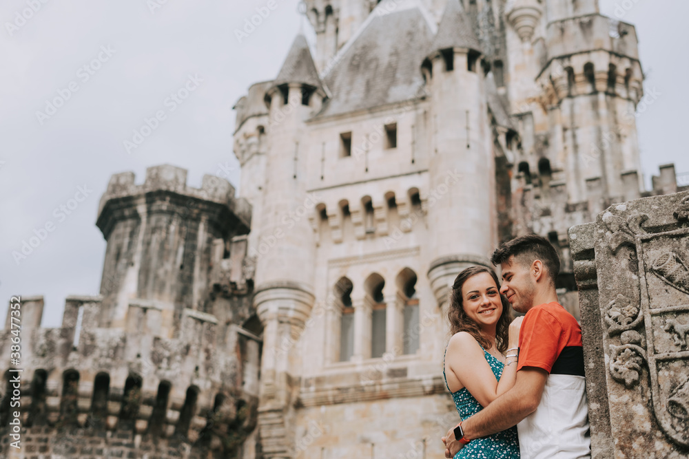Young couple in front of a medieval castle