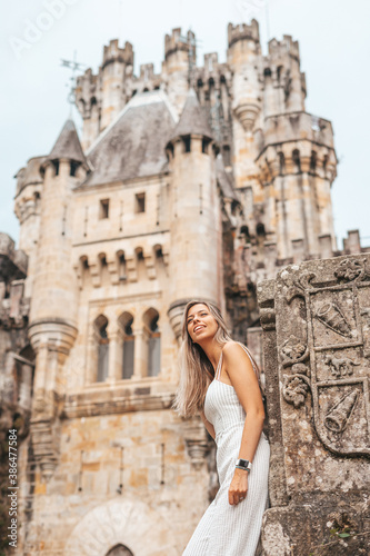 Young woman in front of a medieval castle