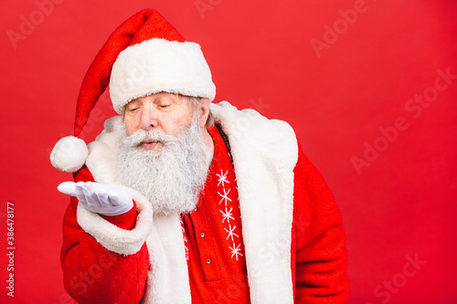 Santa Claus standing isolated on red background. Christmas and new year concept.