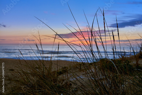 Sunset on the beach of Mar de Fora, Finisterre, Galicia, Spain. This beach is the westernmost beach in Europe, so people go there to see one of the most impressive sunsets in Northern Spain