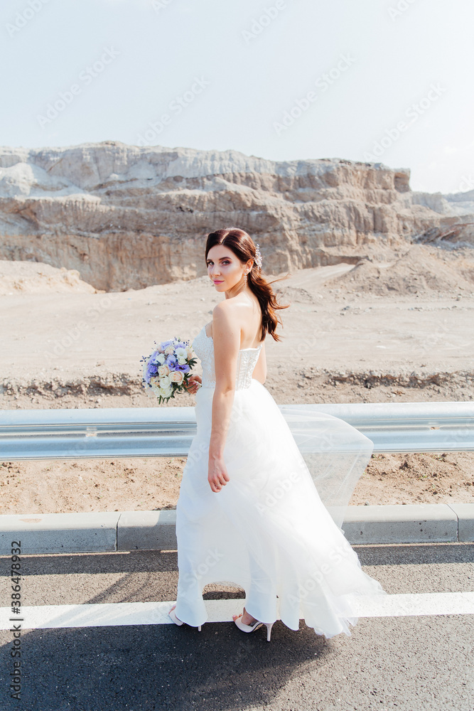 Portrait of a beautiful bride with a bouquet in a white wedding dress Portrait of a beautiful bride with a bouquet in a white wedding dress