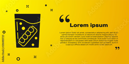 Black False jaw in glass icon isolated on yellow background. Dental jaw or dentures, false teeth with incisors. Vector.
