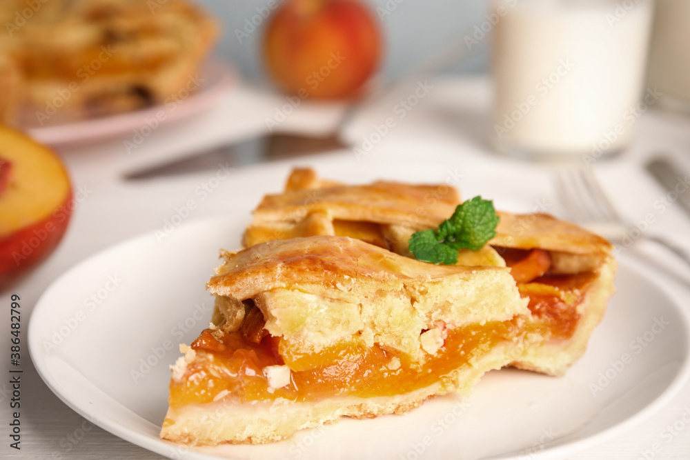 Piece of delicious fresh peach pie served on white table, closeup Piece of delicious fresh peach pie served on white table, closeup
